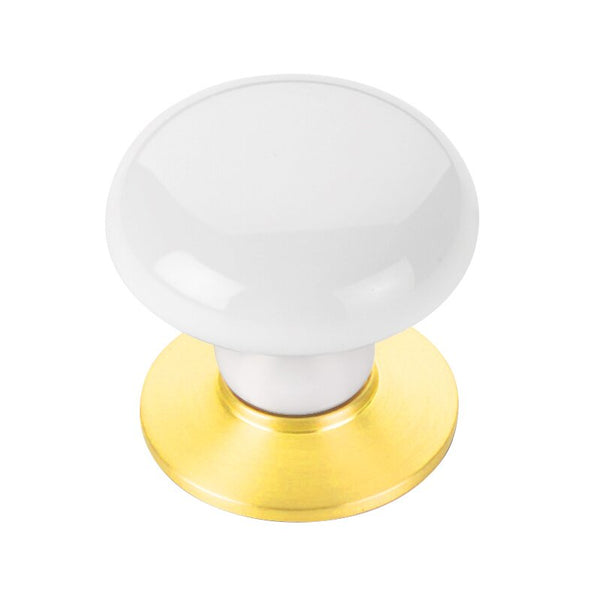 The Emtek Ice White Porcelain Cabinet Knob in Lifetime Polished Brass finish