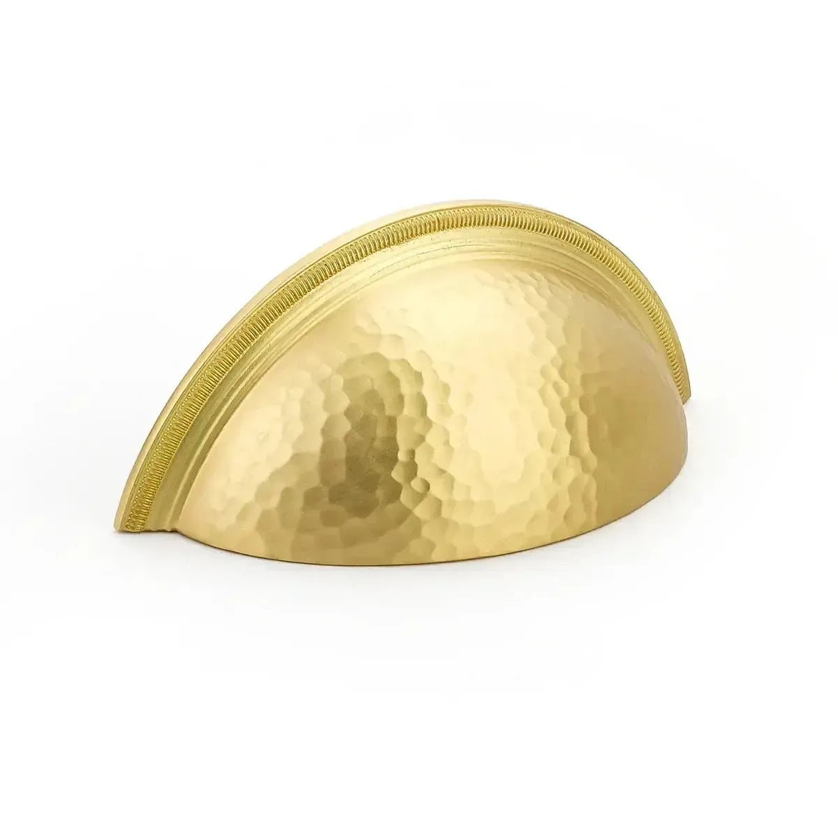 The Schaub Atherton Hammered Knurled Edge Cup Pull in Satin Brass finish.