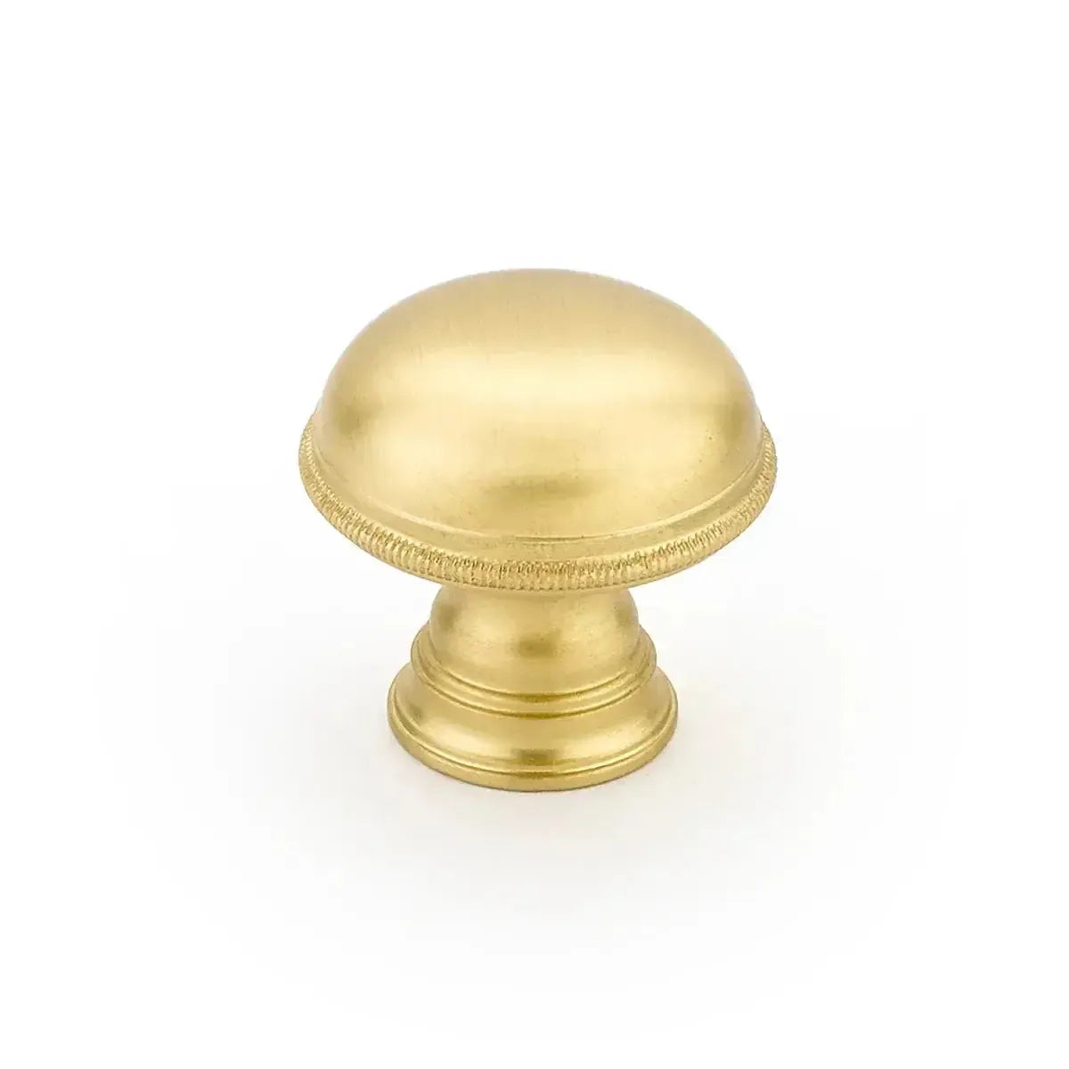 The Schaub Atherton Plain Surface Knurled Edge Cabinet Knob in Satin Brass finish.