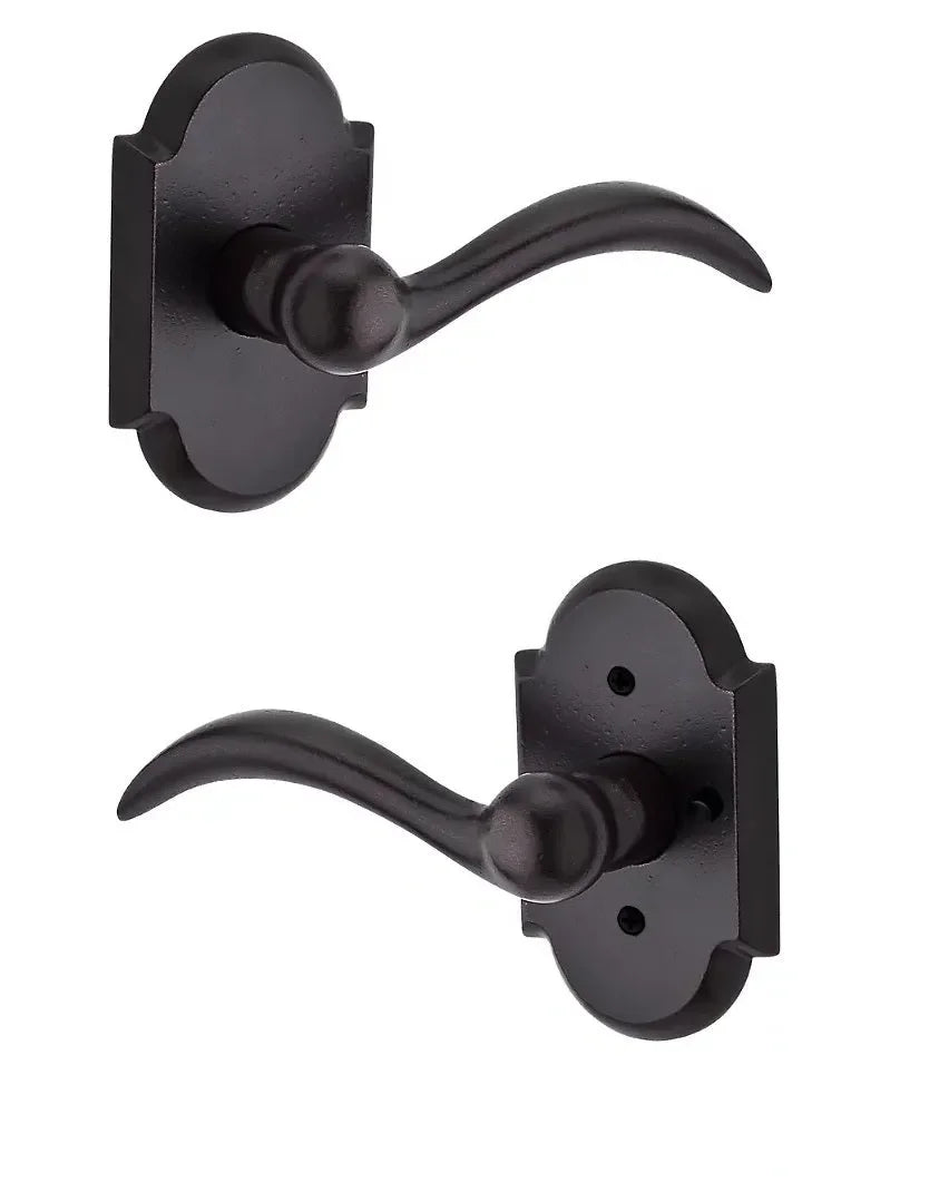 The Baldwin Reserve Arch Lever with Rustic Arch Rosette in Dark Bronze finish.