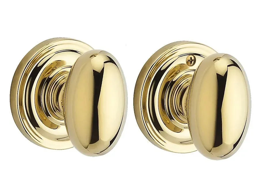 The Baldwin Reserve Ellipse Knob with Traditional Round Rosette in Lifetime Polished Brass finish.