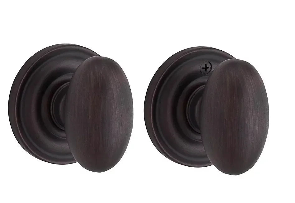 The Baldwin Reserve Ellipse Knob with Traditional Round Rosette in Venetian Bronze finish.