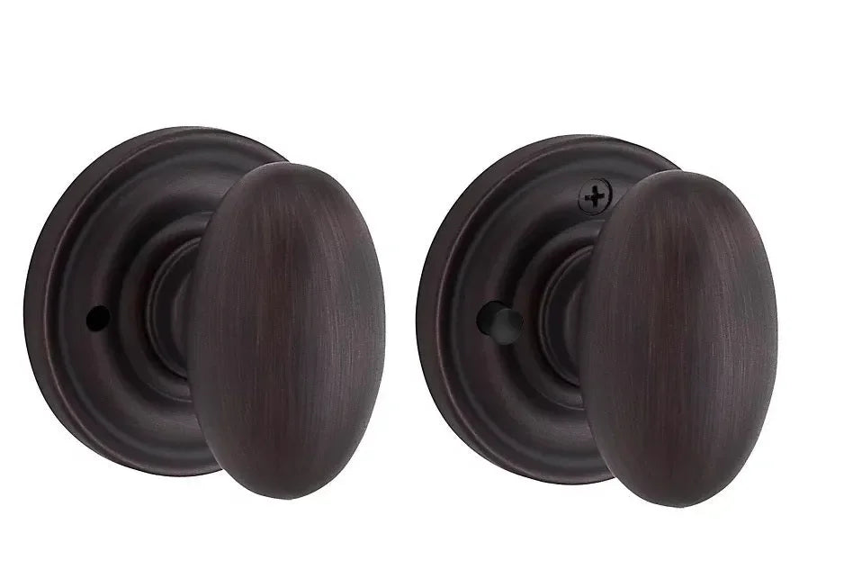 The Baldwin Reserve Ellipse Knob with Traditional Round Rosette in Venetian Bronze finish.