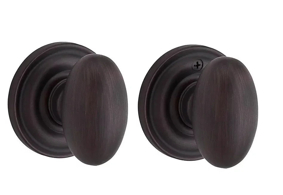 The Baldwin Reserve Ellipse Knob with Traditional Round Rosette in Venetian Bronze finish.