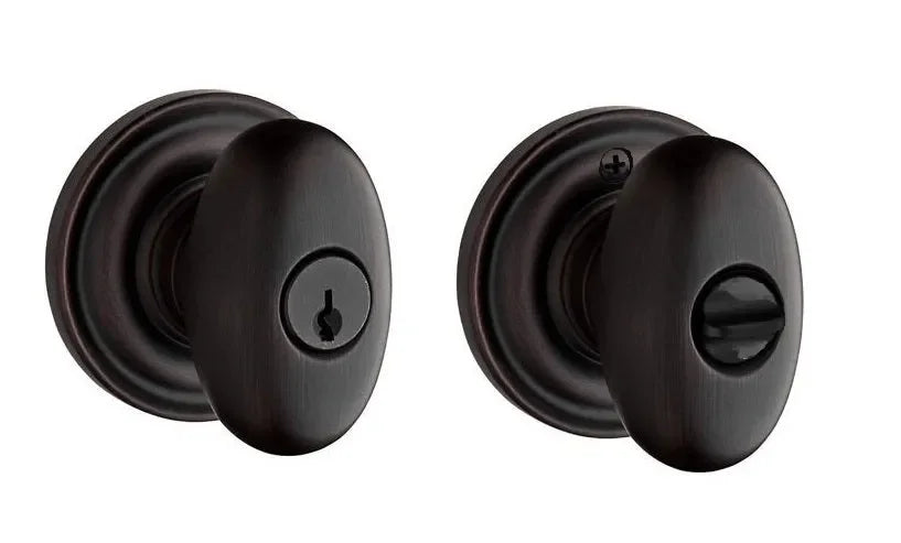 The Baldwin Reserve Ellipse Knob with Traditional Round Rosette in Venetian Bronze finish.