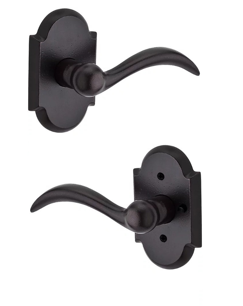 The Baldwin Reserve Arch Lever with Rustic Arch Rosette in Dark Bronze finish.
