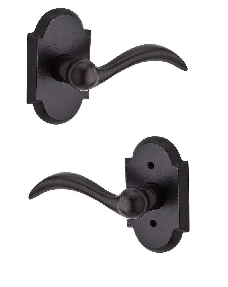 The Baldwin Reserve Arch Lever with Rustic Arch Rosette in Dark Bronze finish.