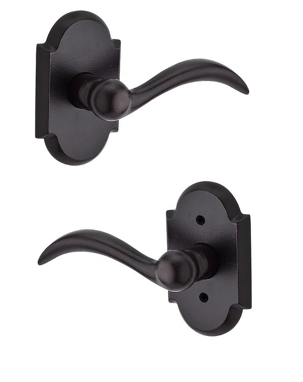 The Baldwin Reserve Arch Lever with Rustic Arch Rosette in Dark Bronze finish.