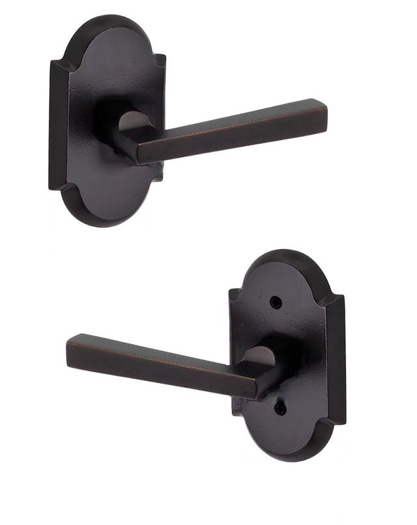 The Baldwin Reserve Taper Lever with Rustic Arch Rosette in Dark Bronze finish.
