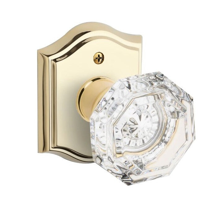 The Baldwin Reserve Crystal Knob with Traditional Arch Rosette in Lifetime Polished Brass finish.