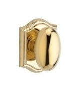 The Baldwin Reserve Ellipse Knob with Traditional Arch Rosette in Lifetime Polished Brass finish.