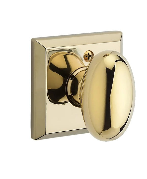 The Baldwin Reserve Ellipse Knob with Traditional Square Rosette in Lifetime Polished Brass finish.