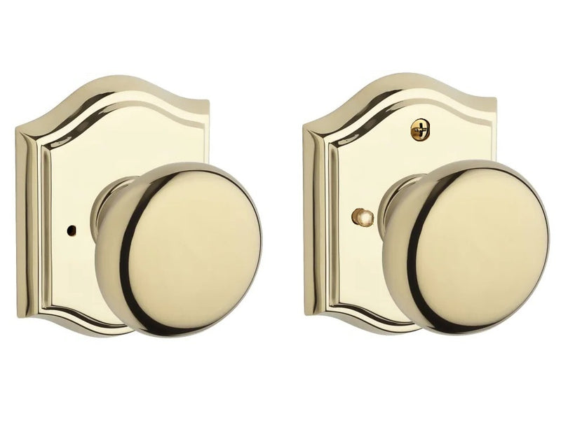 The Baldwin Reserve Round Knob with Traditional Arch Rosette in Lifetime Polished Brass finish.