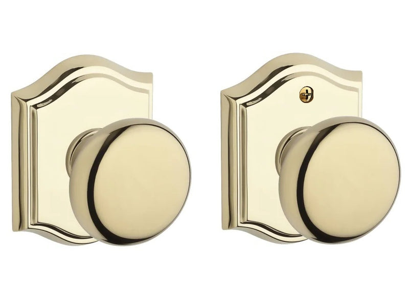 The Baldwin Reserve Round Knob with Traditional Arch Rosette in Lifetime Polished Brass finish.