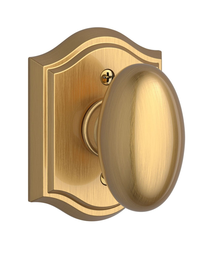 The Baldwin Reserve Ellipse Knob with Traditional Arch Rosette in Lifetime Satin Brass finish.