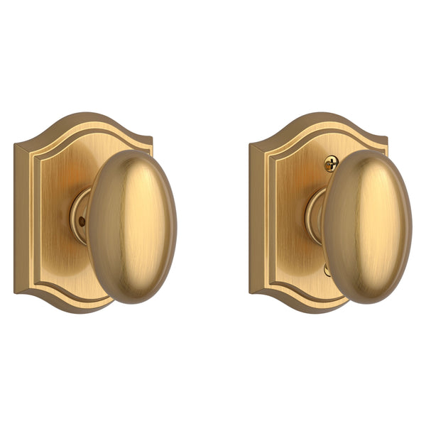The Baldwin Reserve Ellipse Knob with Traditional Arch Rosette in Lifetime Satin Brass finish.