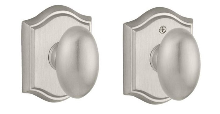 The Baldwin Reserve Ellipse Knob with Traditional Arch Rosette in Satin Nickel finish.