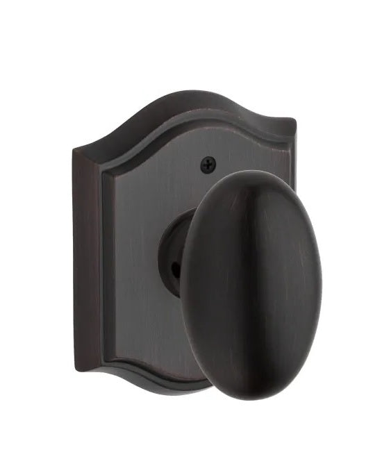 The Baldwin Reserve Ellipse Knob with Traditional Arch Rosette in Venetian Bronze finish.