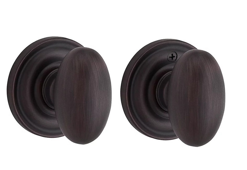 The Baldwin Reserve Ellipse Knob with Traditional Round Rosette in Venetian Bronze finish.