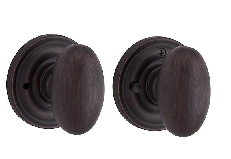 The Baldwin Reserve Ellipse Knob with Traditional Round Rosette in Venetian Bronze finish.