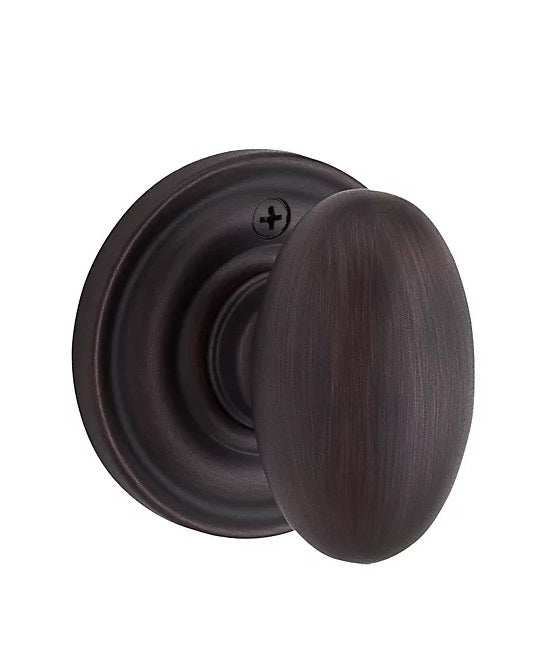 The Baldwin Reserve Ellipse Knob with Traditional Round Rosette in Venetian Bronze finish.