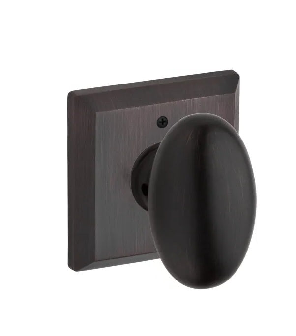 The Baldwin Reserve Ellipse Knob with Traditional Square Rosette in Venetian Bronze finish.
