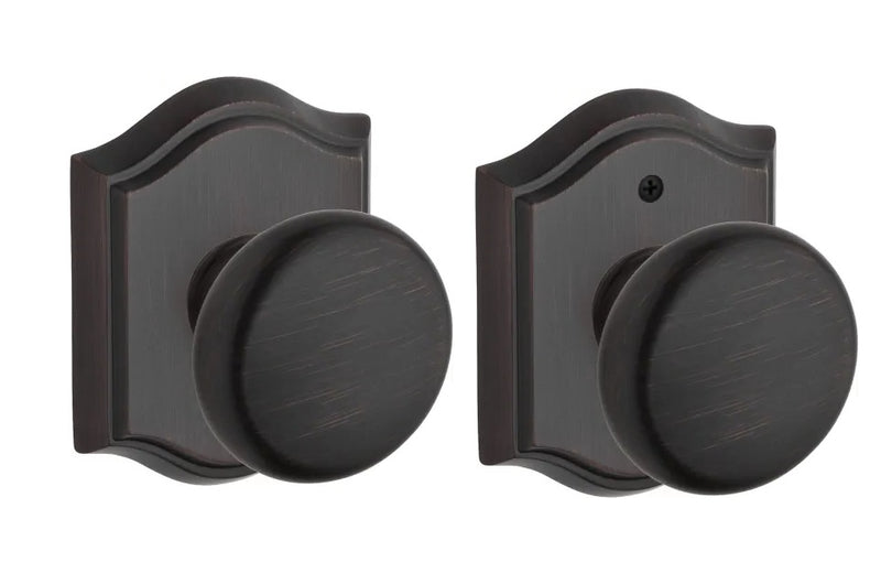 The Baldwin Reserve Round Knob with Traditional Arch Rosette in Venetian Bronze finish.