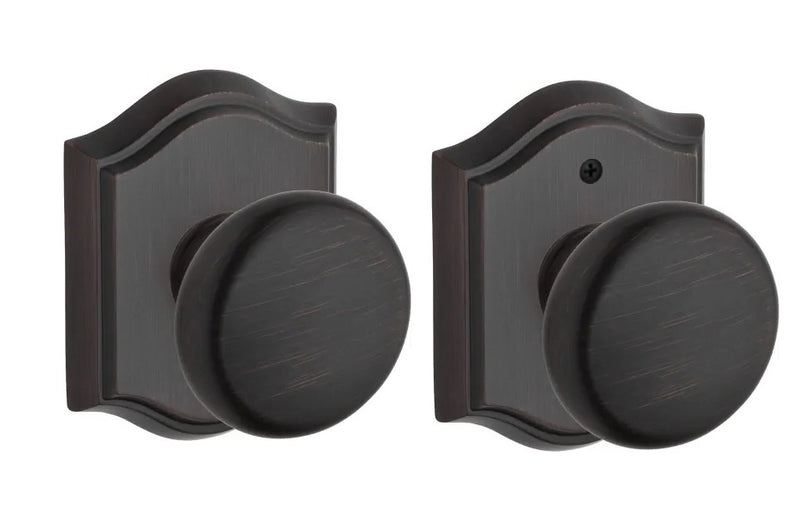 The Baldwin Reserve Round Knob with Traditional Arch Rosette in Venetian Bronze finish.