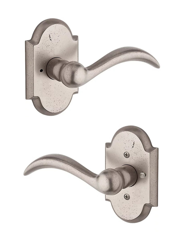The Baldwin Reserve Arch Lever with Rustic Arch Rosette in White Bronze finish.