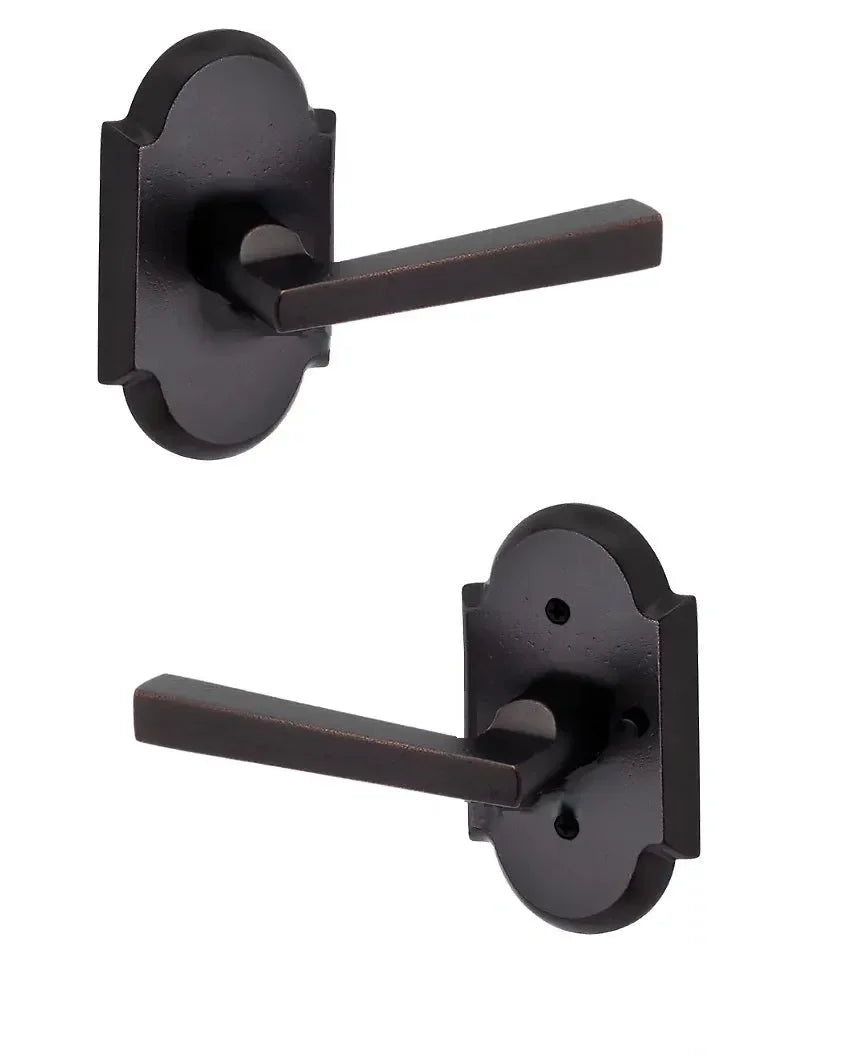 The Baldwin Reserve Taper Lever with Rustic Arch Rosette in Dark Bronze finish.