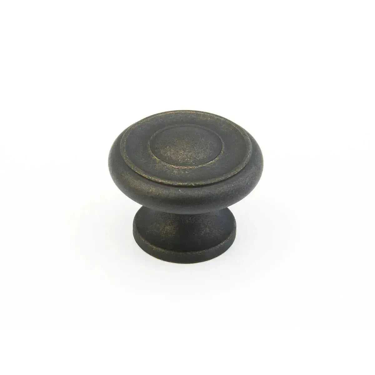 The Schaub Traditional Stepped Round Cabinet Knob in Distressed Bronze finish.