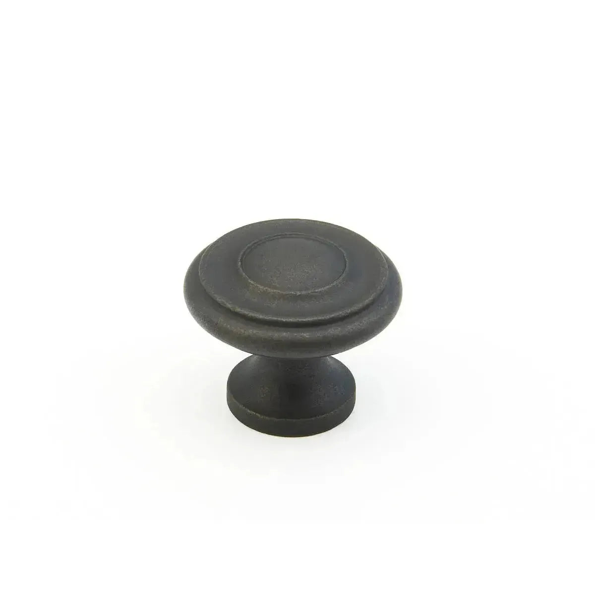 The Schaub Traditional Stepped Round Cabinet Knob in Distressed Bronze finish.