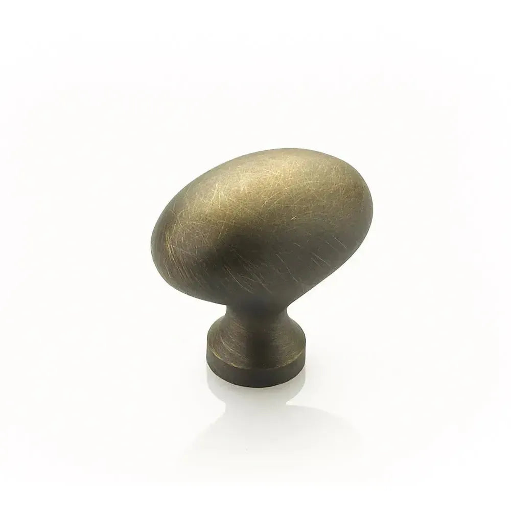 The Schaub Country Oval Cabinet Knob in Antique Light Brass finish.
