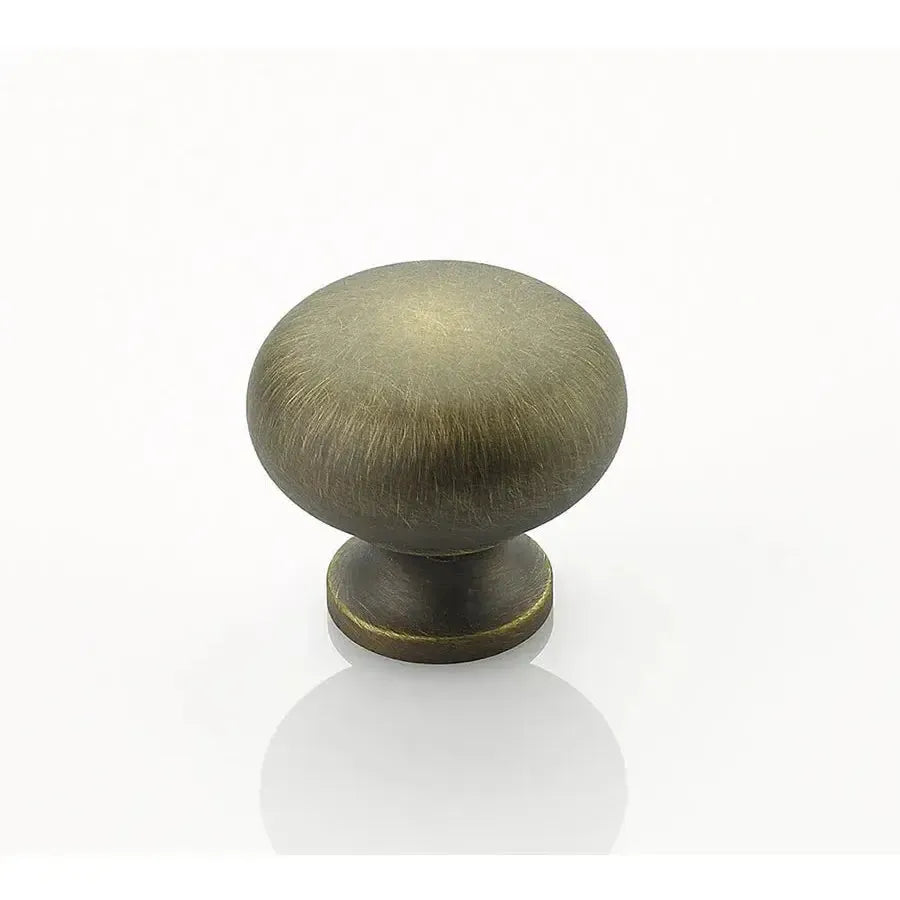 The Schaub Traditional Round Cabinet Knob in Antique Light Brass finish.