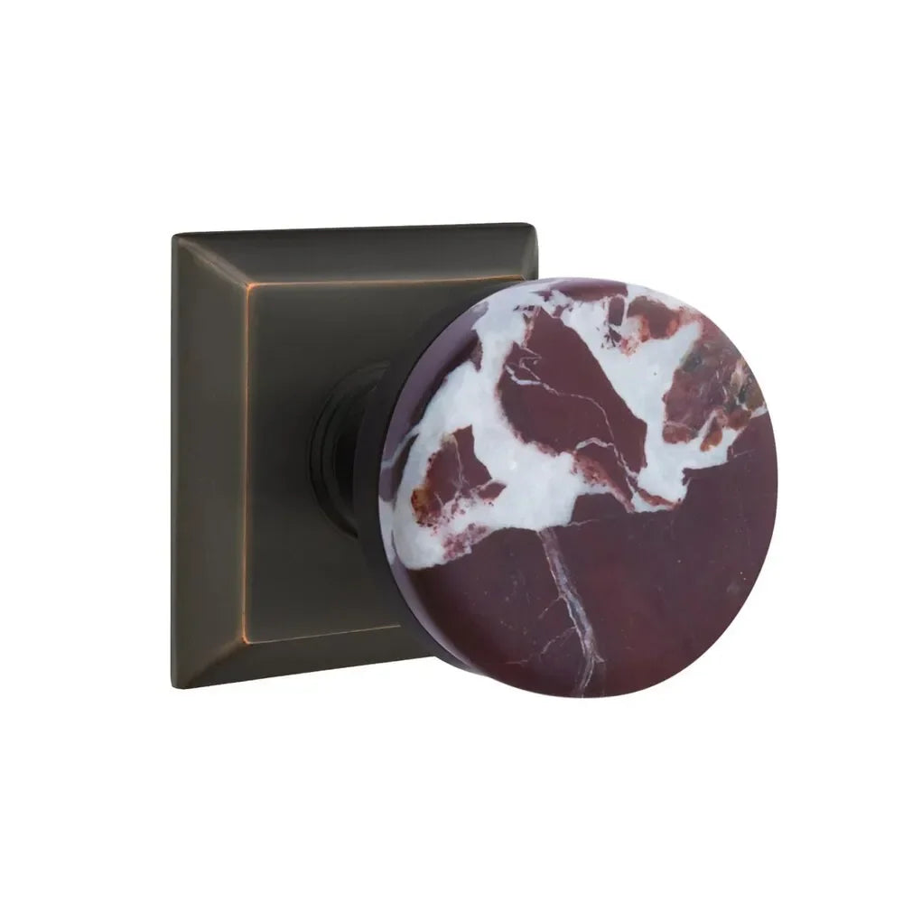The Emtek Select Conical Rosso Levanto Marble Knobset with Quincy Rosette in Oil Rubbed Bronze finish.