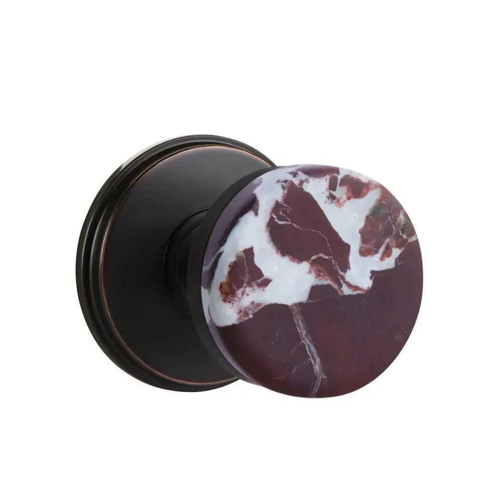 The Emtek Select Conical Rosso Levanto Marble Knobset with Watford Rosette in Oil Rubbed Bronze finish.