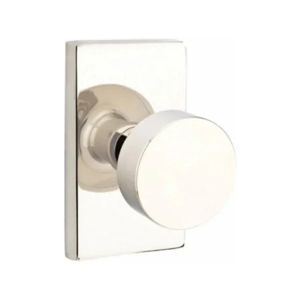 The Emtek Round Knob With Modern Rectangular Rosette in Lifetime Polished Nickel finish.