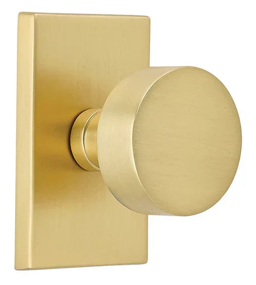 The Emtek Round Knob With Modern Rectangular Rosette in Satin Brass finish.