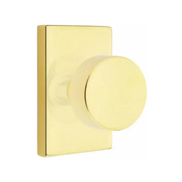 The Emtek Round Knob With Modern Rectangular Rosette in Unlacquered Brass finish.