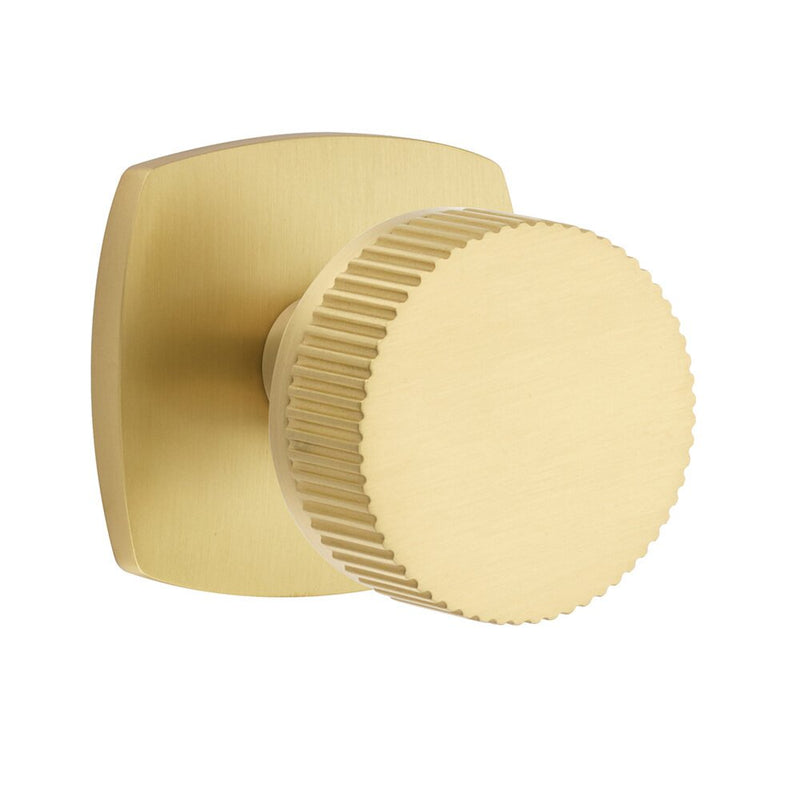 The Emtek Passage Select Conical Straight Knurled Knob with Urban Modern Rosette in Satin Brass finish