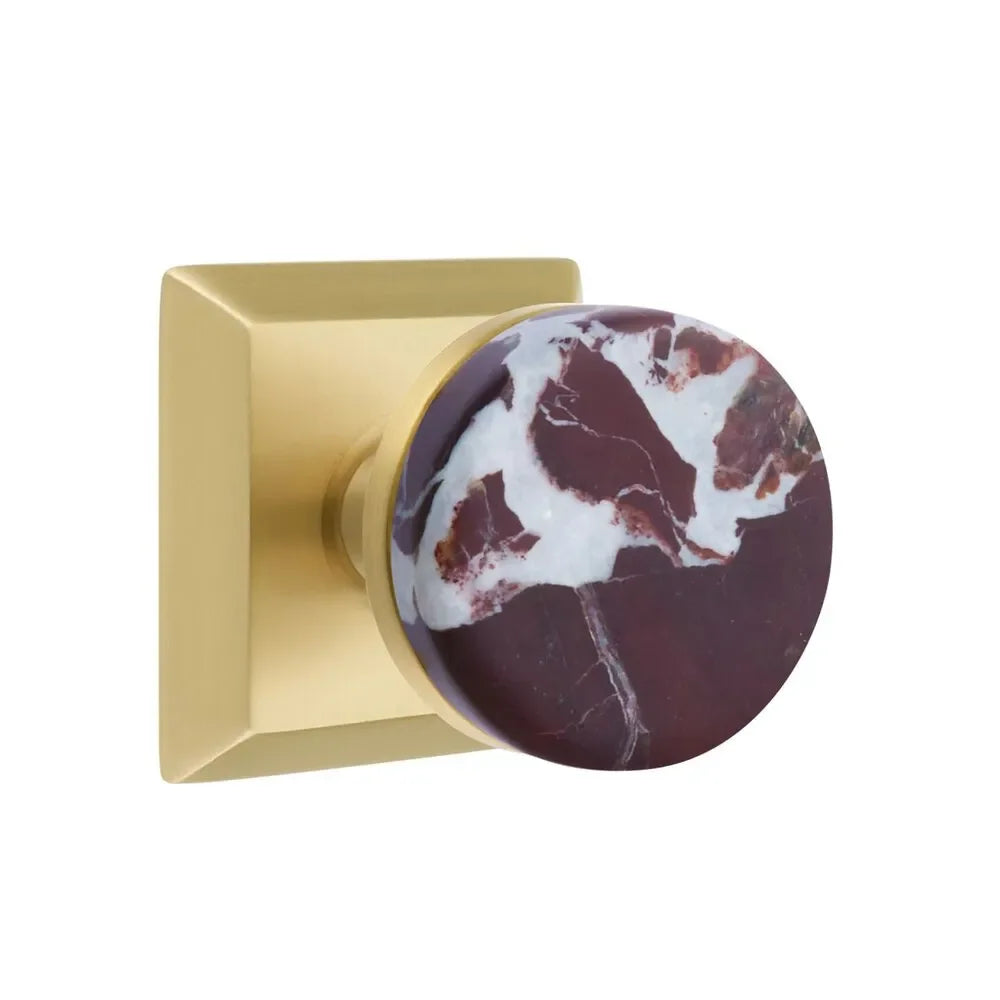 The Emtek Select Conical Rosso Levanto Marble Knobset with Quincy Rosette in Satin Brass finish.