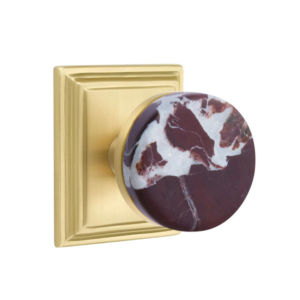 The Emtek Select Conical Rosso Levanto Marble Knobset with Wilshire Rosette in Satin Brass finish.