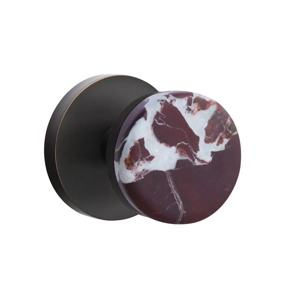 The Emtek Select Conical Rosso Levanto Marble Knobset with Disk Rosette in Oil Rubbed Bronze finish.