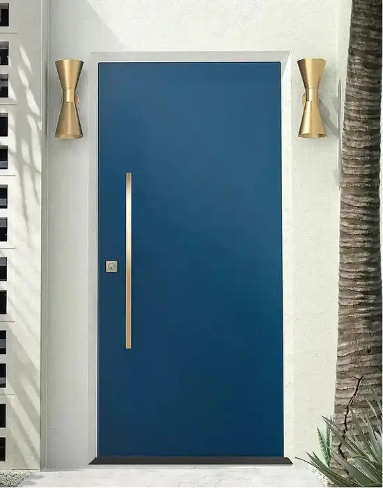 Blue door with gold handles on a white wall with decorative elements