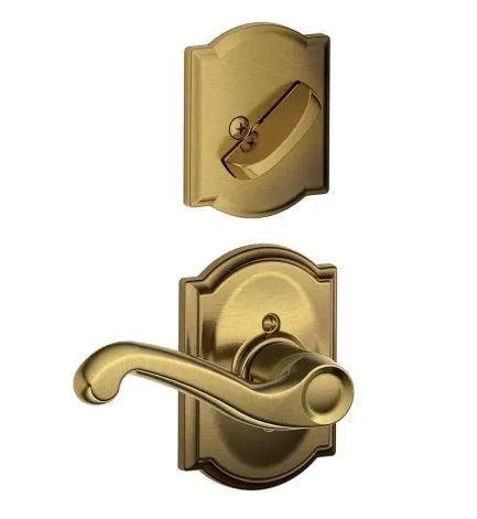 The Schlage Right Hand Flair Lever With Camelot Rosette Interior Active Trim - Exterior Handleset Sold Separately in Antique Brass finish