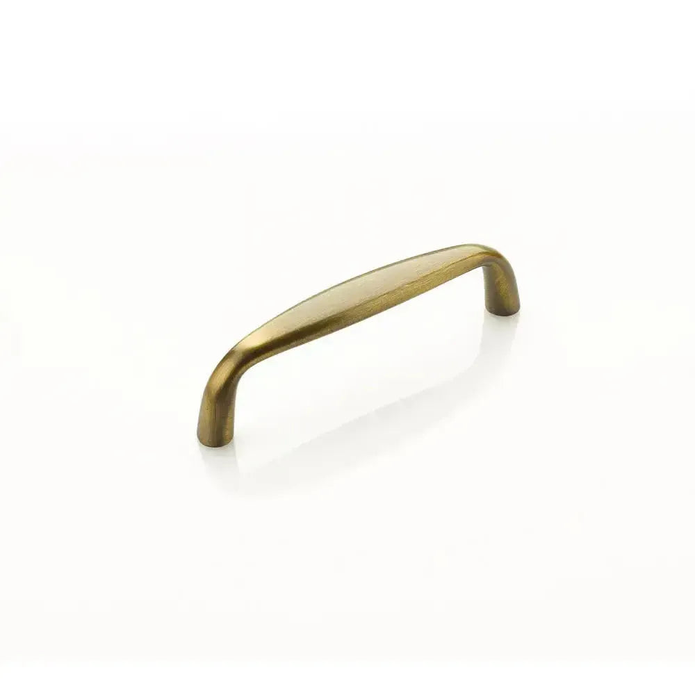 The Schaub Traditional Cabinet Pull in Antique Brass finish.