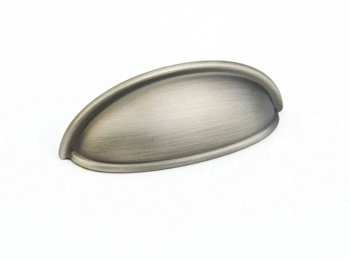 The Schaub Traditional Cup Cabinet Pull in Antique Nickel finish.